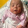 baby, bedding, blanket, calm, close_up, face, hands, head, hospital, indoor, infant, newborn, photography, pink_clothing, portrait, resting, sleeping, striped_blanket, sunlight, swaddle