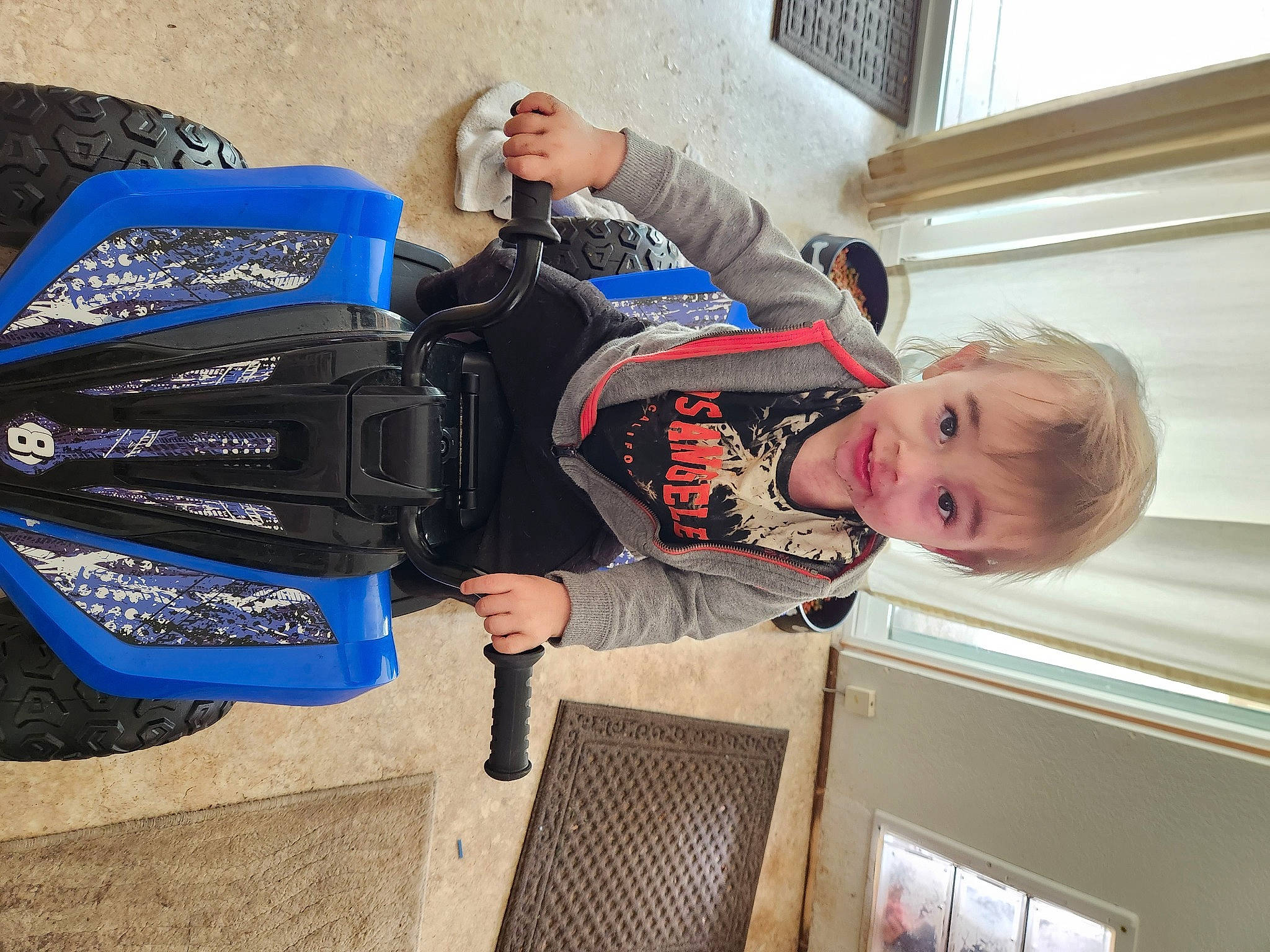 Shane joined the competition — help win amazing prizes! auto_part, automotive_exterior, baby_toddler_clothing, backpack, bag, blue, bumper, child, electric_blue, fun, joy, luggage_and_bags, person, personal_protective_equipment, recreation, sitting, smile, toddler, travel, vehicle
