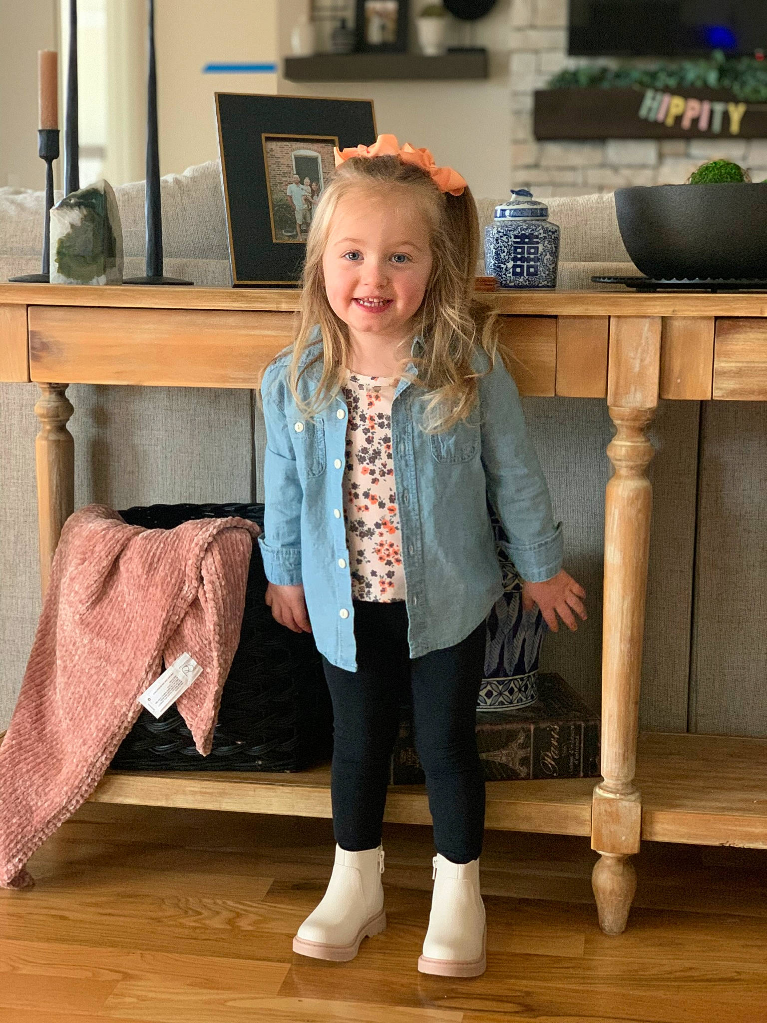 Parker is registered to the contest to win money with this photo: blazer, fashion_design, floor, flooring, happy, hardwood, human_leg, joint, joy, knee, leg, outerwear, person, room, sitting, sleeve, smile, standing, table, thigh