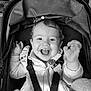 baby, child, infant, stroller, car_seat, harness, smile, laugh, teeth, tongue, hoodie, zipper, buckle, hand, canopy, portrait, black_and_white, indoor, cute, happy