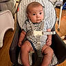 baby, infant, child, baby_seat, striped_clothing, safety_harness, indoor, wooden_floor, furniture, high_chair, seat, person, cute, young_child, home, living_room, expression, face, small_hands, legs