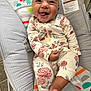 Haylee joined the competition — help win amazing prizes! baby, child, smiling, pajamas, floral_pattern, bouncer, infant, tongue_out, face, cute, happy, indoors, seat, playful, colorful, warning_label, clothing, person, foot, closeup