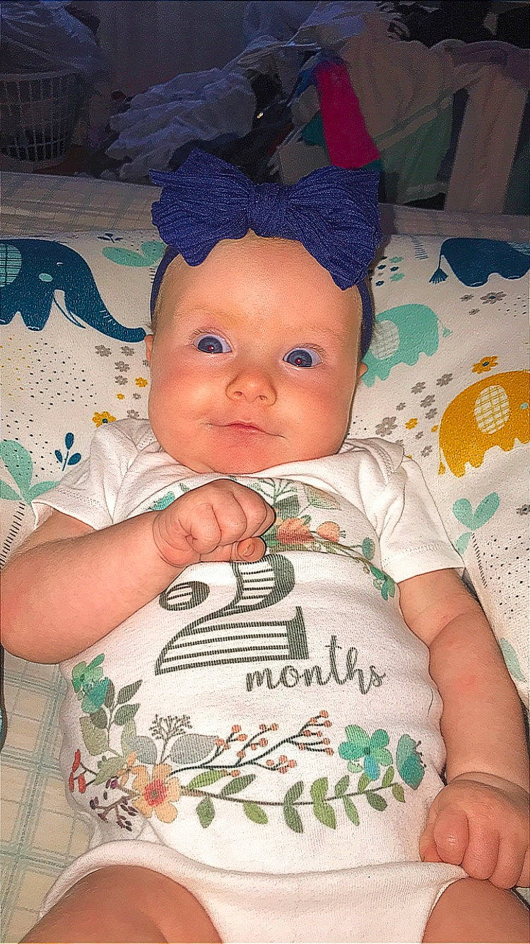 Raelynn is registered to the contest to win money with this photo: baby, baby_products, baby_toddler_clothing, cheek, child, eye, finger, fun, happy, headwear, iris, linens, lip, mouth, nose, person, pink, skin, sleeve, t_shirt