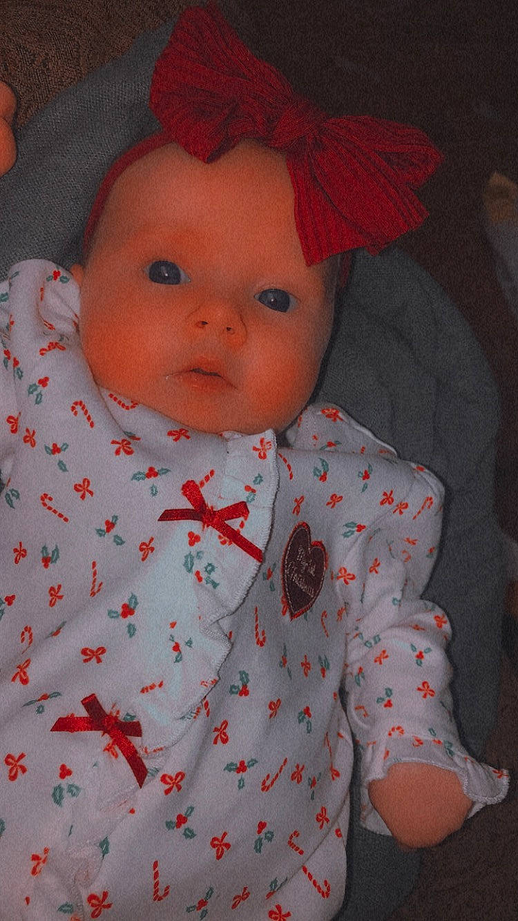 Raelynn is registered to the contest to win money with this photo: baby, baby_toddler_clothing, cap, carmine, cheek, child, chin, collar, costume_hat, dress_shirt, head, linens, lip, nose, outerwear, pattern, person, red, skin, sleeve