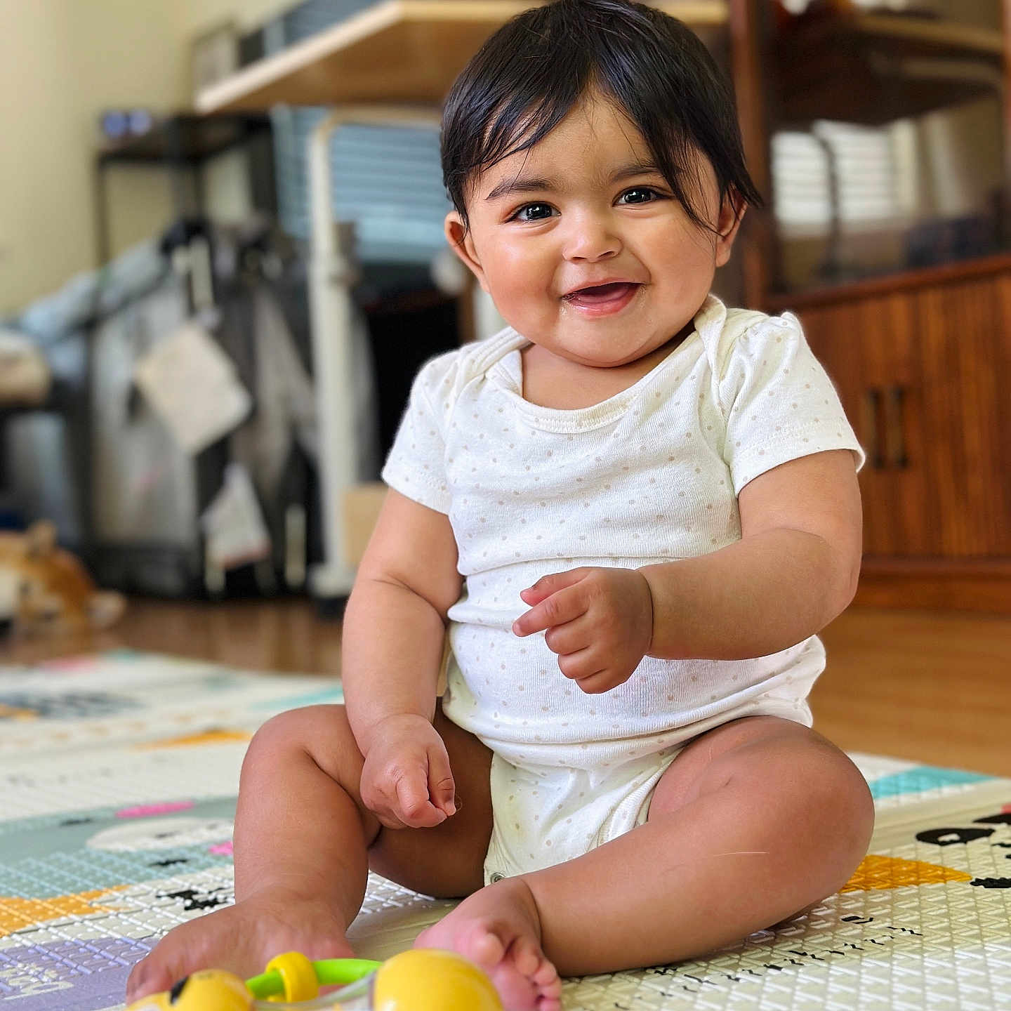 Kiansha joined the competition — help win amazing prizes! baby, bodypart, clothing, couch, face, finger, furniture, hand, happy, hardwood, head, indoors, person, photography, portrait, shelf, sitting, smile, toy, wood
