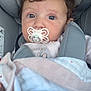 Diana participe au concours pour gagner de l'argent avec cette photo : baby, pacifier, car_seat, blanket, child, face, curly_hair, infant, cute, indoor, person, seatbelt, comfort, soft_toys, clothing, portrait, young_child, head_support, resting, closeup