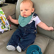Lyle is registered to the contest to win money with this photo: baby, baby_sock, bib, blanket, blue_eyes, car_interior, car_seat, child, clothing, cute, denim_overalls, expression, face, head, infant, interior, leather_seat, person, seat_belt, sitting