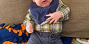 Lyle joined the competition — help win amazing prizes! baby, bib, blanket, blue_eyes, casual_clothing, child, comfortable, couch, cozy, cute, expression, green_socks, indoor, infant, navy_pants, person, plaid_shirt, seated, soft_fabric, young
