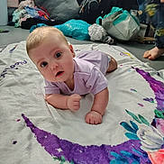 Morgna joined the competition — help win amazing prizes! baby, child, infant, blanket, purple, crescent_moon, floral, floor, indoors, clothing, onesie, curious, face, expression, hand, foot, person, background, bag, pile_of_clothes