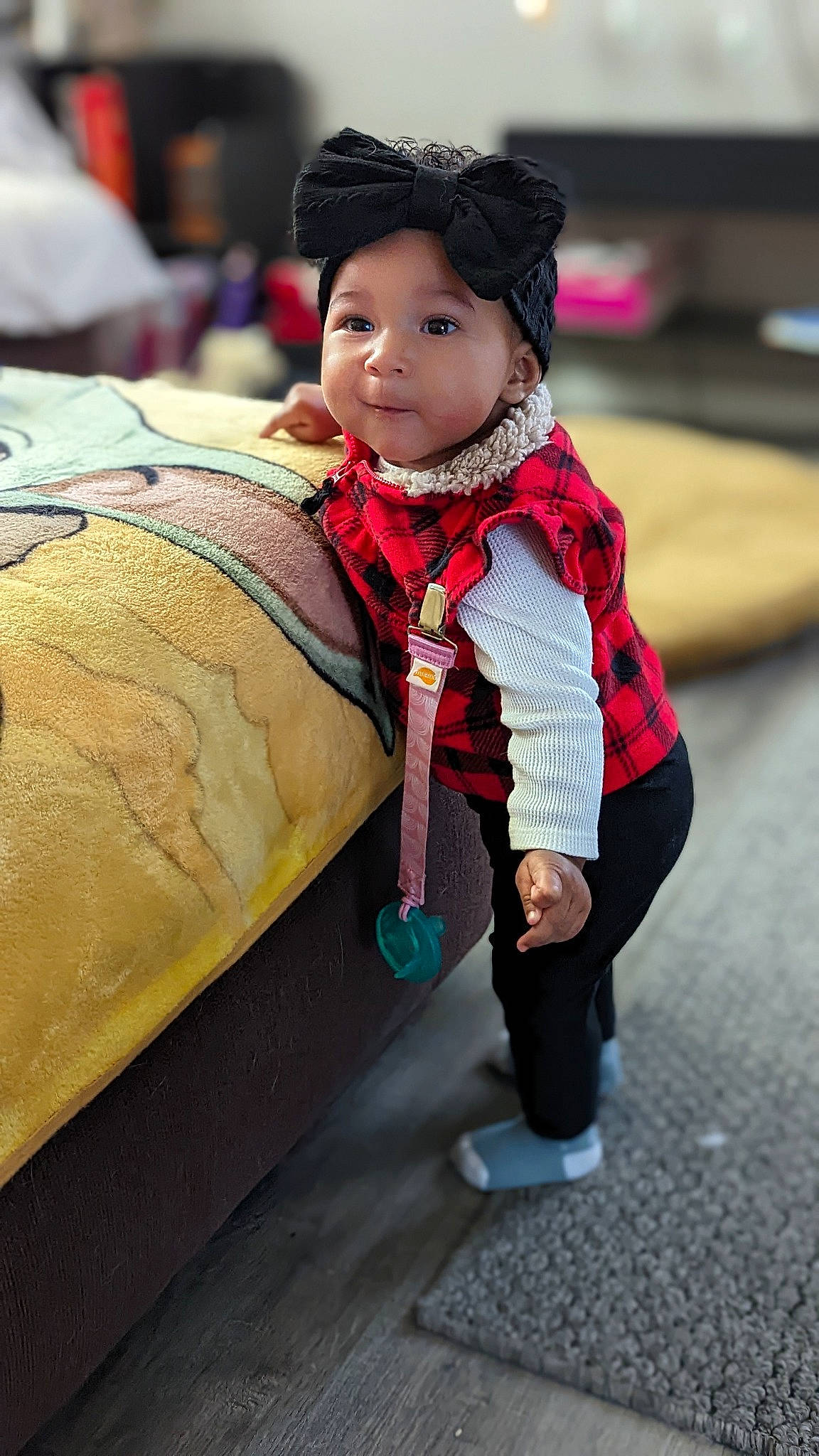Jurnee is registered to the contest to win money with this photo: baby, black_hair, cap, child, fashion_accessory, flooring, fur, happy, headwear, leisure, magenta, pattern, person, road, sitting, skin, sleeve, street, toddler, tradition
