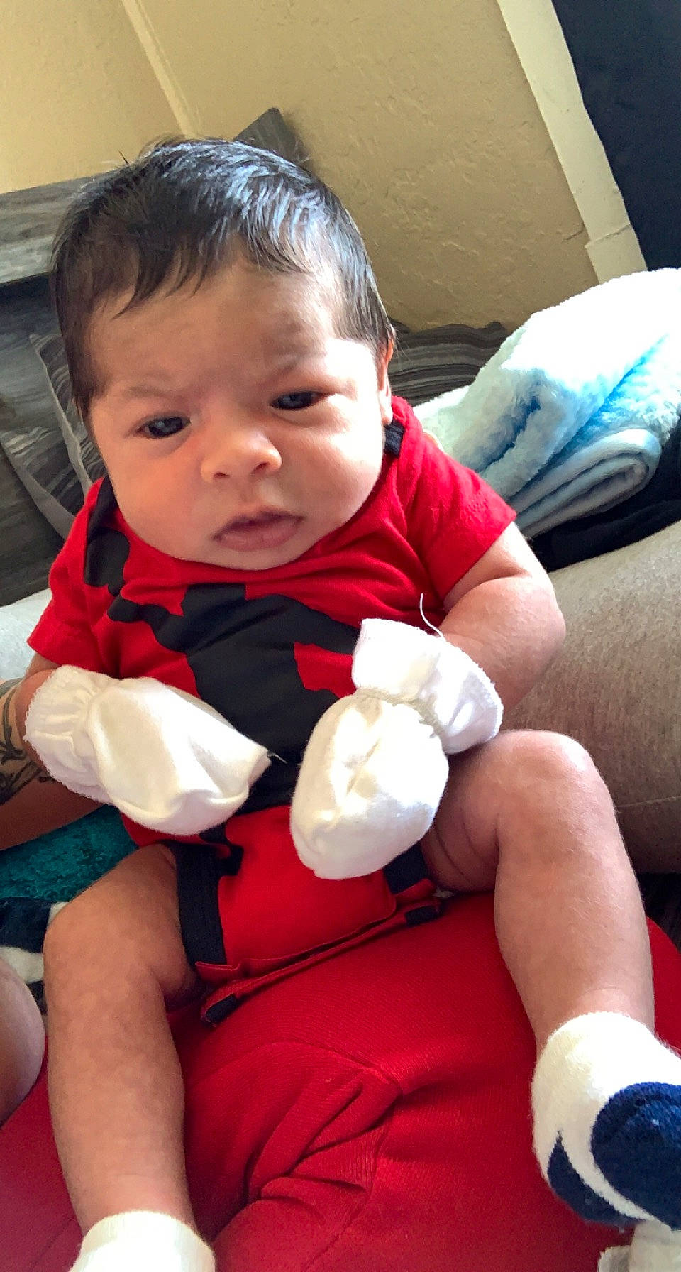 Zachariah joined the competition — help win amazing prizes! baby, baby_toddler_clothing, cheek, child, comfort, face, finger, happy, human_leg, knee, lap, mouth, nail, person, personal_protective_equipment, sitting, skin, textile, thigh, thumb