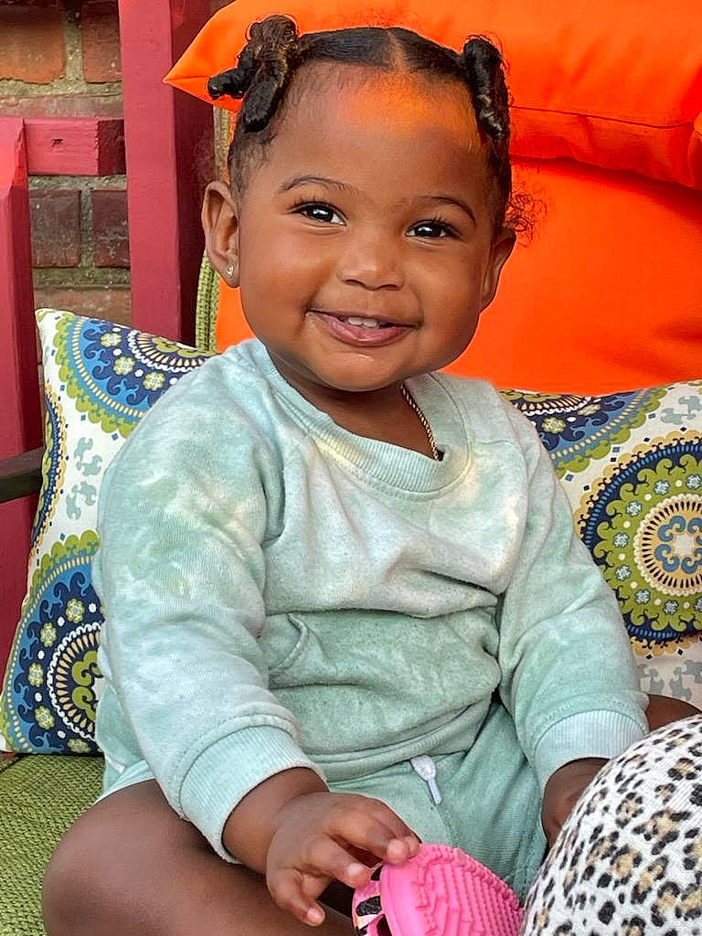 Aubrey is registered to the contest to win money with this photo: baby_toddler_clothing, cheek, child, comfort, couch, eye, face, hair, hairstyle, happy, head, human_body, iris, joy, person, sitting, skin, sleeve, smile, sunglasses