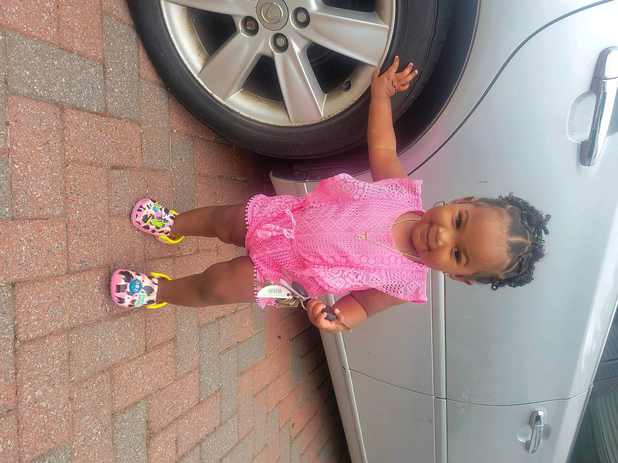 Aubrey joined the competition — help win amazing prizes! alloy_wheel, automotive_design, automotive_exterior, automotive_lighting, automotive_tire, car, clothing, door, dress, fender, hubcap, joy, motor_vehicle, person, pink, rim, tire, toddler, tread, vehicle