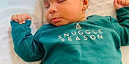 Zayne is registered to the contest to win money with this photo: baby, sleeping, green_sweater, snuggle_season, blanket, infant, peaceful, cozy, cute, child, portrait, indoors, soft_texture, resting, hands_up, closed_eyes, casual_clothing, young_child, cute_expression, relaxation