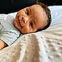 Zayne joined the competition — help win amazing prizes! baby, smile, face, infant, blanket, clothing, lying_down, cute, portrait, young_child, happy, skin, head, eyes, soft_texture, indoors, cozy, closeup, person, child