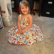 Violet joined the competition — help win amazing prizes! child, girl, smile, dress, floral_pattern, carpet, indoor, furniture, mattress, plastic_wrap, happy, portrait, sitting, short_hair, person, room, cabinet, clothing, floor, casual