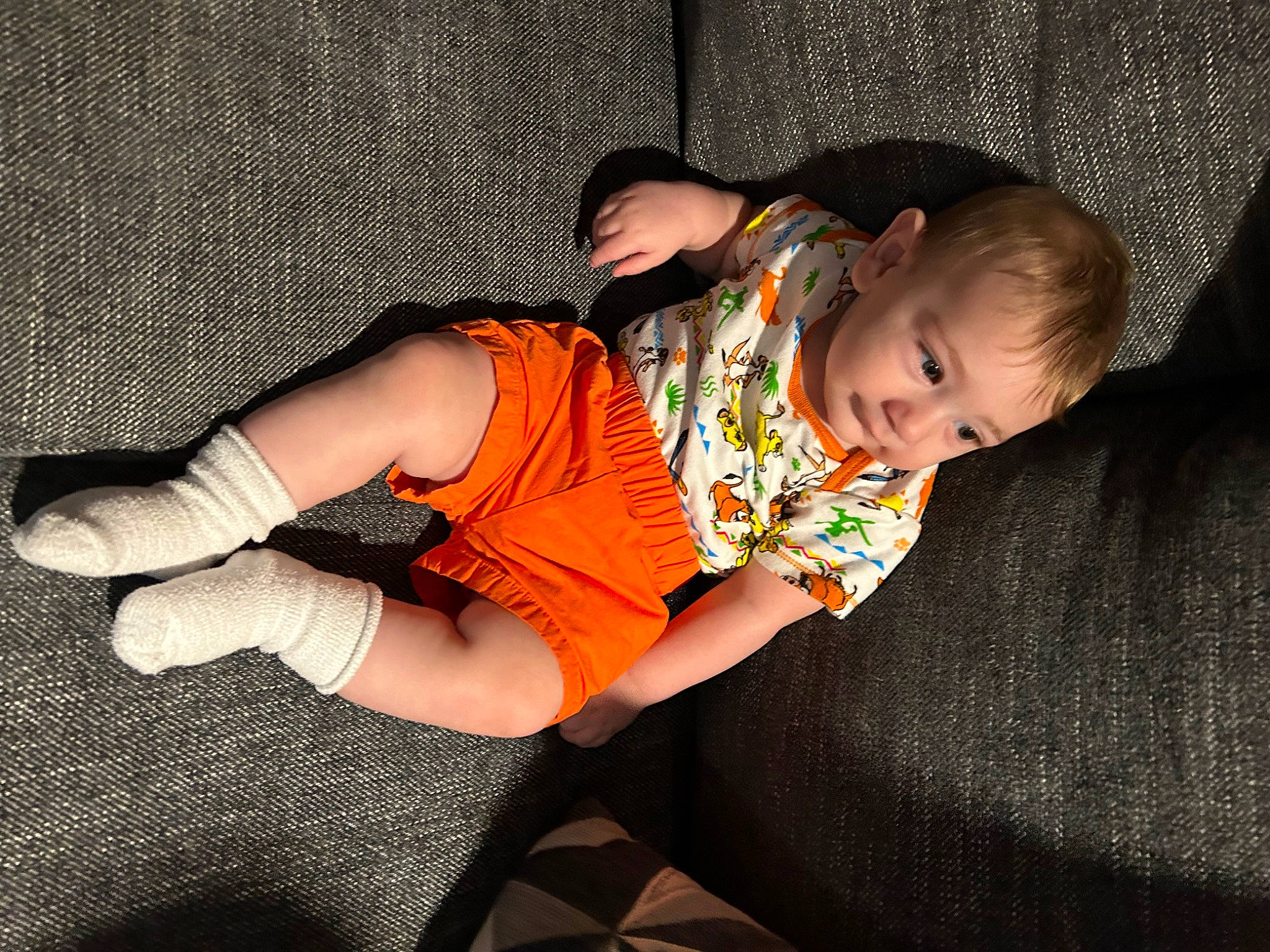 Meliodas is registered to the contest to win money with this photo: abdomen, baby, baby_products, baby_toddler_clothing, child, comfort, elbow, flash_photography, human_leg, knee, linens, pattern, person, room, sitting, skin, sleeve, sock, t_shirt, thigh