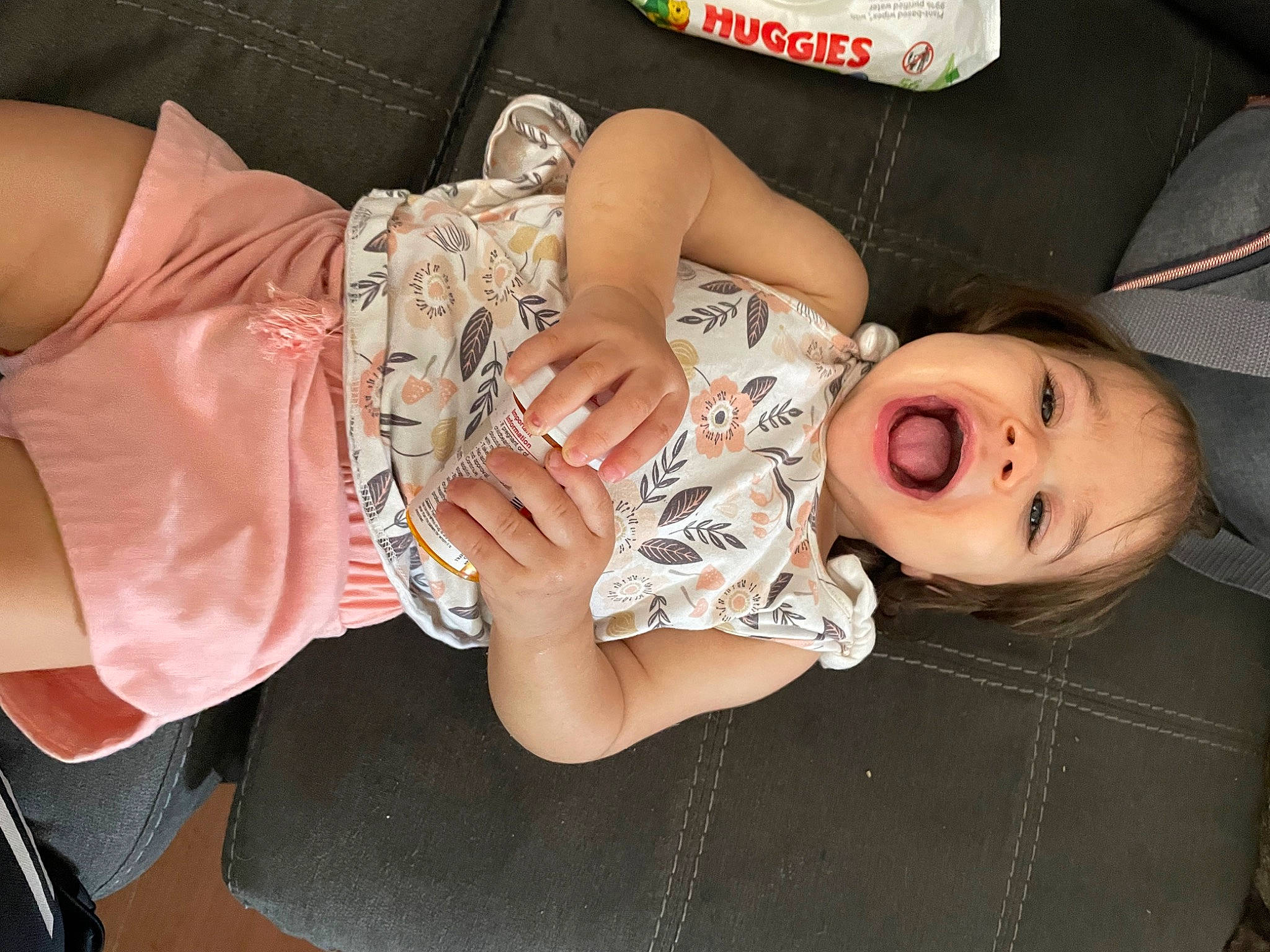 Felicity is registered to the contest to win money with this photo: arm, comfort, elbow, eyelash, eyewear, finger, hand, happy, human_body, human_leg, leg, mouth, nail, person, pink, sleeve, sunglasses, thigh, toddler, trunk