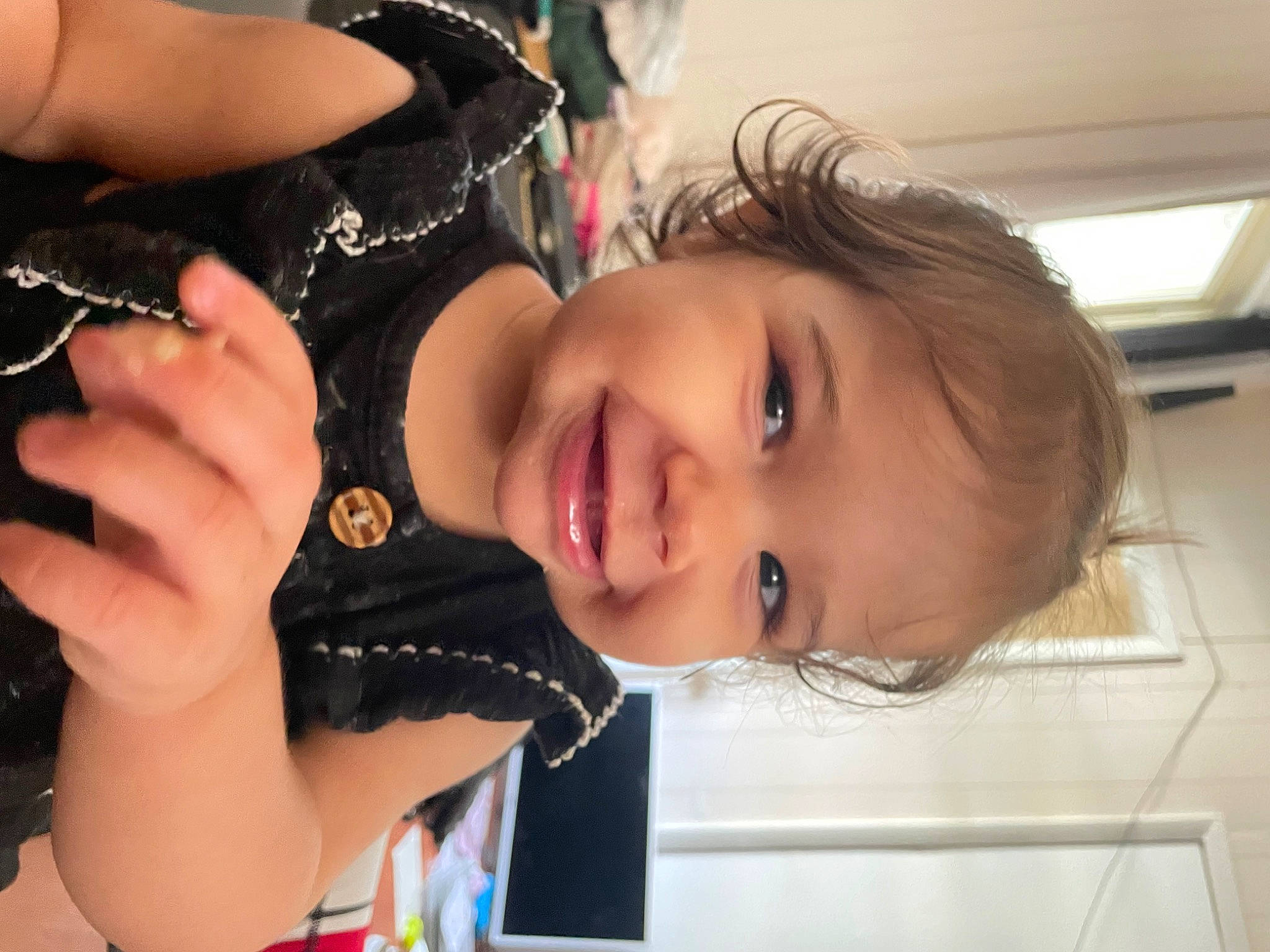 Felicity is registered to the contest to win money with this photo: child, dress, event, eyebrow, eyelash, facial_expression, fashion_accessory, finger, fun, gesture, happy, jewellery, joy, lip, nose, person, skin, smile, thumb, toddler