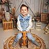 Teo participe au concours pour gagner de l'argent avec cette photo : background, boy, casual_clothing, child, decor, denim_jeans, flowers, happy, hoodie, indoor, lantern, patterned_rug, playful, portrait, rug, rustic, smile, sneakers, wooden_crate, wooden_tricycle
