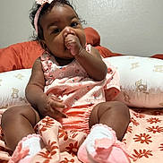 Schrhyia joined the competition — help win amazing prizes! baby, infant, child, thumb_sucking, pink_clothing, headband, sock, blanket, floral_pattern, pillow, teddy_bear, cute, indoors, portrait, sitting, curly_hair, soft_lighting, young_child, comfort, adorable