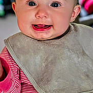 Elicia joined the competition — help win amazing prizes! baby, infant, smile, tongue, bib, clothing, pink_stripes, face, child, cute, portrait, indoors, happy, cheeks, eyes, head, person, baby_clothes, closeup, skin