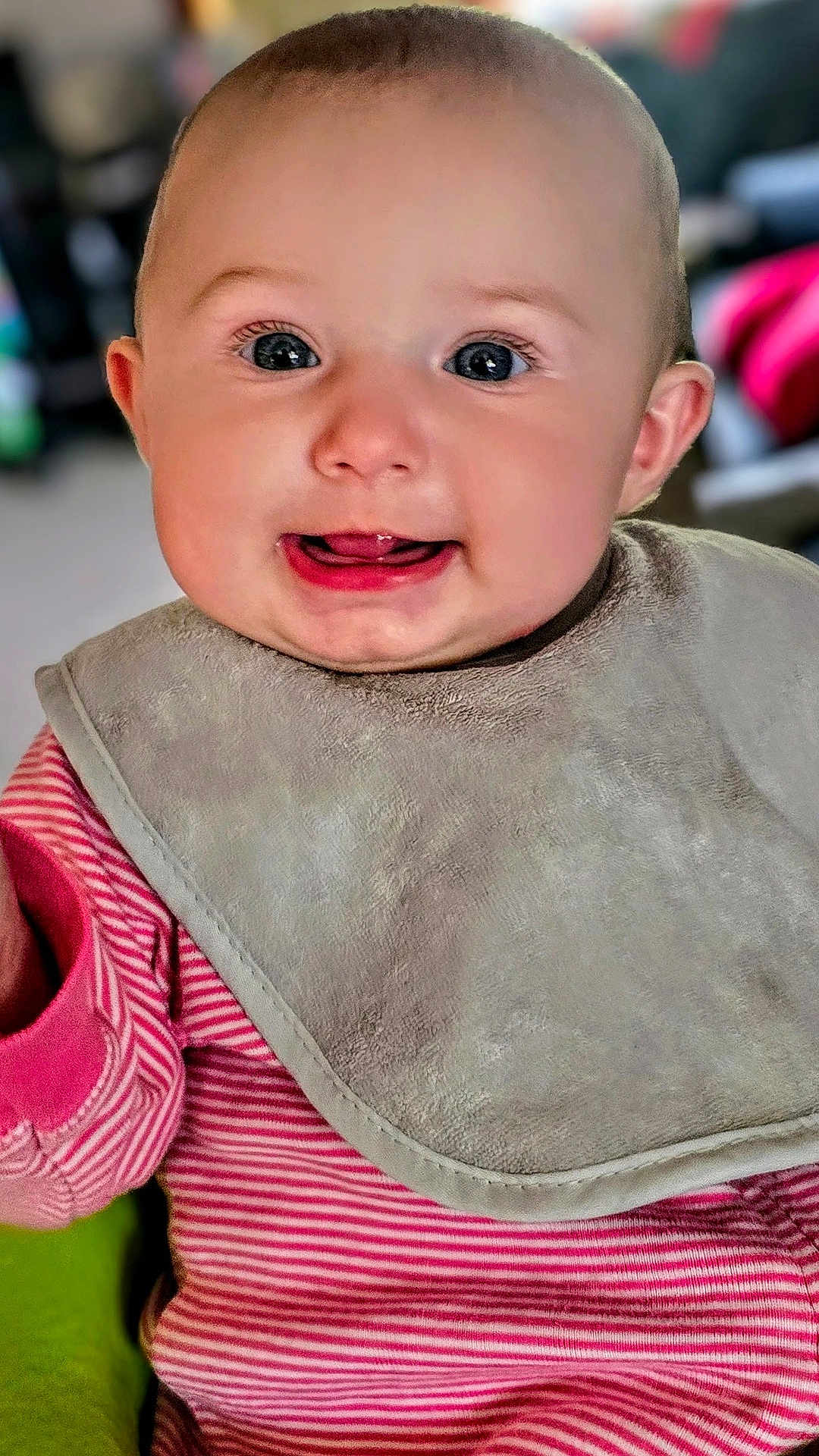 Elicia joined the competition — help win amazing prizes! baby, infant, smile, tongue, bib, clothing, pink_stripes, face, child, cute, portrait, indoors, happy, cheeks, eyes, head, person, baby_clothes, closeup, skin