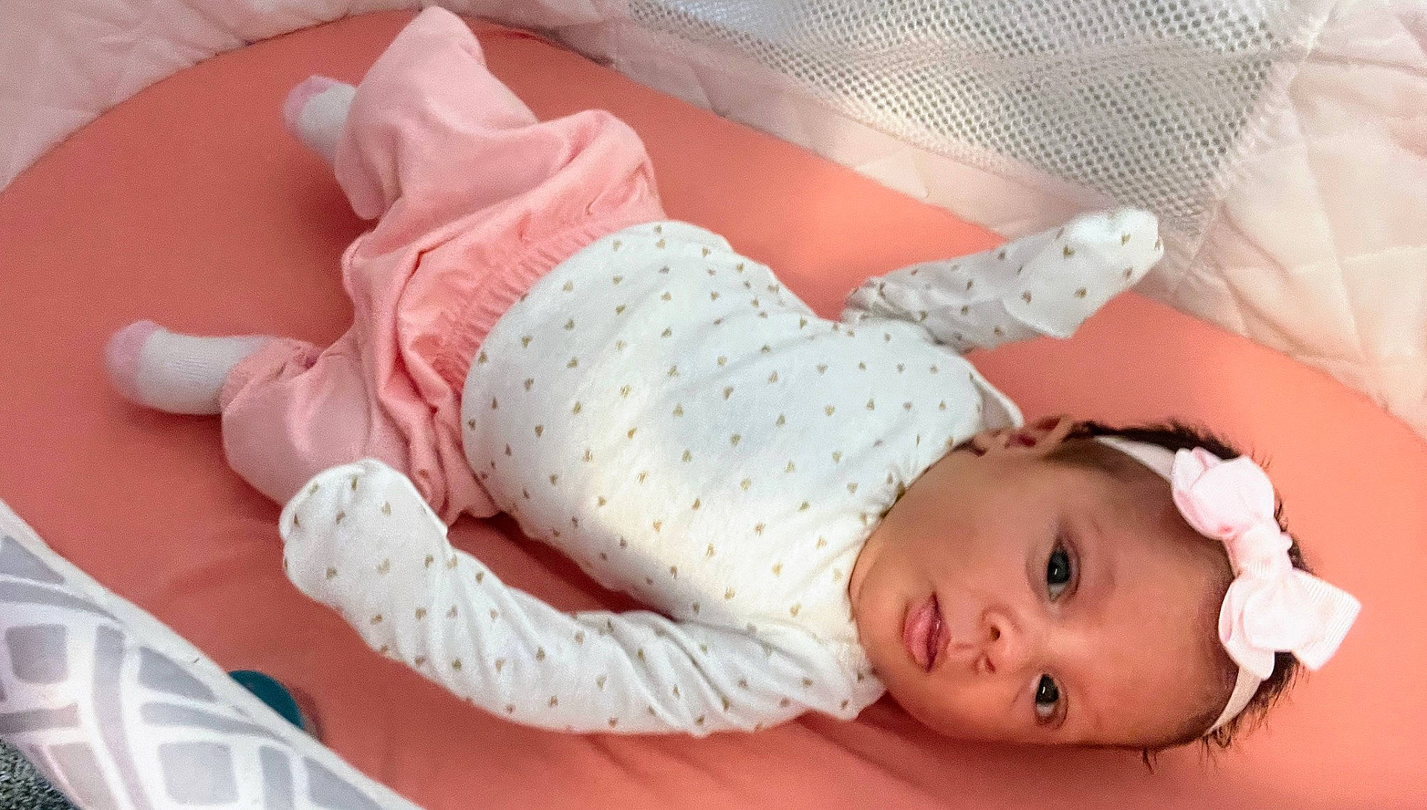 Amaya is registered to the contest to win money with this photo: arm, baby, baby_products, baby_safety, baby_sleeping, baby_toddler_clothing, bed, bedding, child, comfort, hand, infant_bed, linens, pattern, person, pink, skin, sleeve, textile, toddler