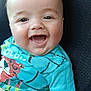 baby, smiling, child, car_seat, turquoise_shirt, happy, face, infant, clothing, person, portrait, seat, cute, young_child, skin, head, sitting, casual, close_up, cheerful