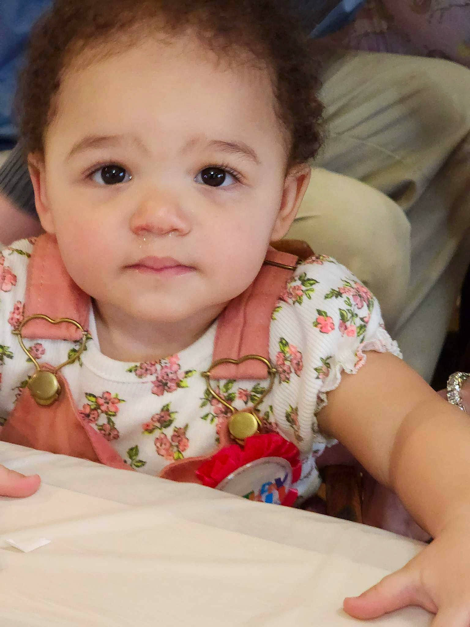 Kailani is registered to the contest to win money with this photo: baby, baby_toddler_clothing, cheek, child, comfort, dress, event, eyelash, facial_expression, finger, fun, hand, happy, iris, lip, mouth, nose, person, skin, sleeve