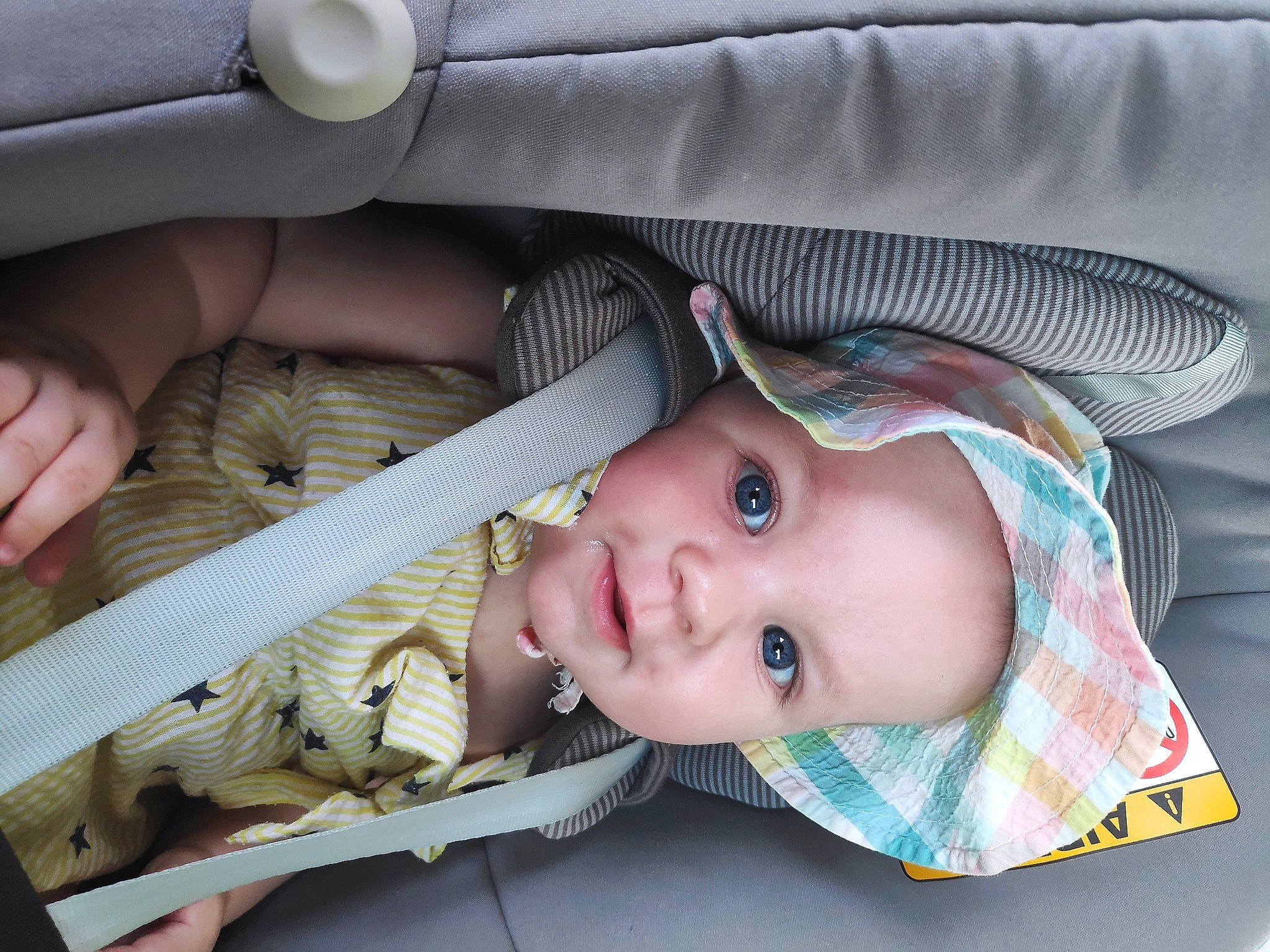 Hanna is registered to the contest to win money with this photo: auto_part, baby, baby_carriage, baby_products, baby_safety, baby_toddler_clothing, car_seat, car_seat_cover, cheek, child, comfort, face, mammal, person, product, sitting, skin, toddler, vertebrate, white