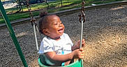 King joined the competition — help win amazing prizes! car, child, clothing, daytime, fence, fun, grass, happiness, joy, motion, outdoor, playground, shoes, smile, summer, sunlight, swing, toddler, trees, woodchips