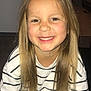 child, smiling, indoor, long_hair, blonde_hair, striped_shirt, happy, portrait, person, casual_clothing, young, face, cute, seated, light_skin, childhood, joyful, human, looking_at_camera, sitting