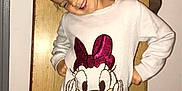 Ivanna a rejoint le concours — aidez-le/la à gagner de superbes lots ! child, smiling, white_sweater, minnie_mouse, pink_leggings, indoor, wooden_panel, playful_pose, happy, person, fashion, hair_bun, closed_eyes, casual_clothing, floor, wall, home, cute, portrait, standing