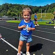Saylor Lynn is registered to the contest to win money with this photo: adult, child, clothing, face, female, footwear, girl, grass, head, male, man, person, racket, running, runningtrack, shoe, shorts, sport, tennis, tennisracket
