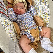 Skarlett joined the competition — help win amazing prizes! baby, baby_seat, child, comfortable, cushion, cute, fabric, floral_outfit, flower, headband, indoors, infant, pacifier, patterned, resting, sleepy, sock, soft_toys, toddler, white_sock