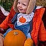 Brodie is registered to the contest to win money with this photo: toddler, child, pumpkin, orange_jacket, denim_overalls, furry_hat, smiling, outdoor, autumn, fall, harvest, cute, nature, grass, hay, seasonal, happy, portrait, baby, warm_clothing