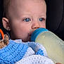 Brodie is registered to the contest to win money with this photo: baby, blanket, blue_eyes, bottle, car_seat, child, close_up, cute, face, feeding, hand, indoors, infant, knitted_blanket, milk, person, portrait, soft_toy, toddler, warm