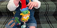 Brodie is registered to the contest to win money with this photo: baby, blue_eyes, child, clothing, colorful, cute, denim_overalls, fire_truck, happy, indoor, infant, person, plaid, playing, plush_toy, smiling, socks, stairs, texture, toddler