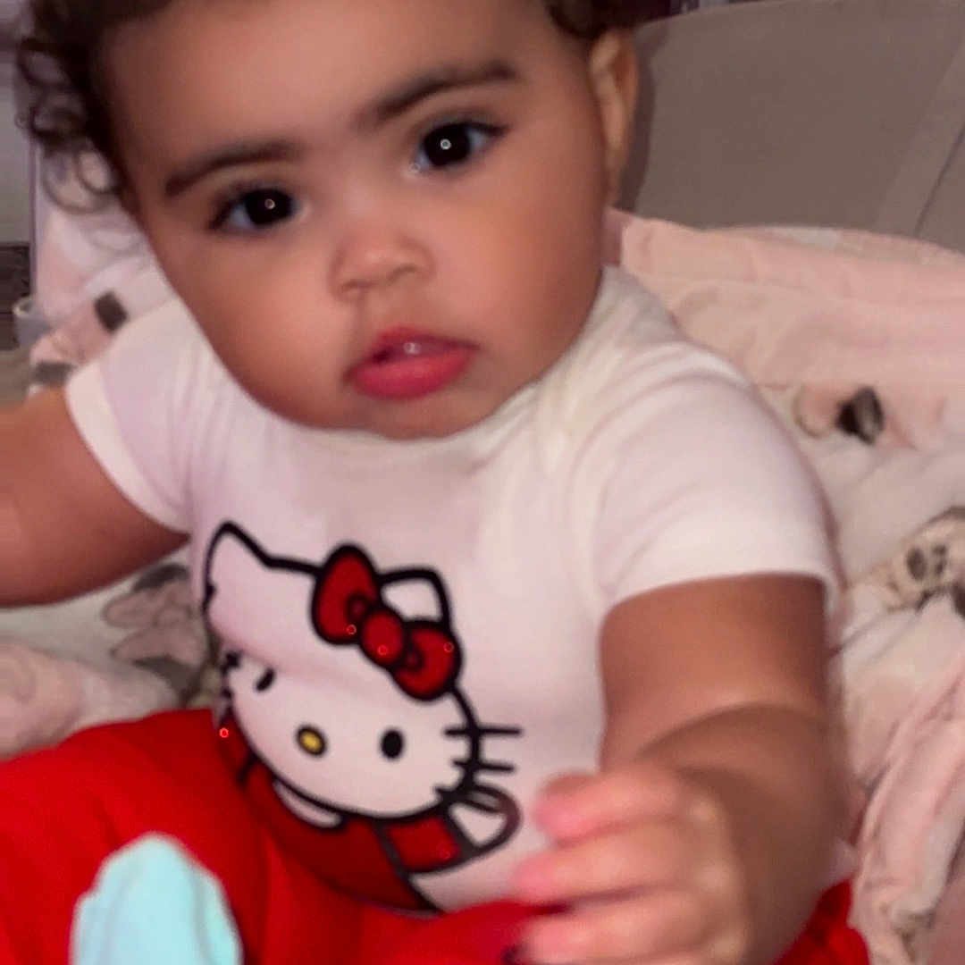 Zendeyah is registered to the contest to win money with this photo: baby, bed, bodypart, clothing, couch, cushion, face, finger, furniture, glove, hand, head, homedecor, hosiery, indoors, person, photography, portrait, sitting, t_shirt