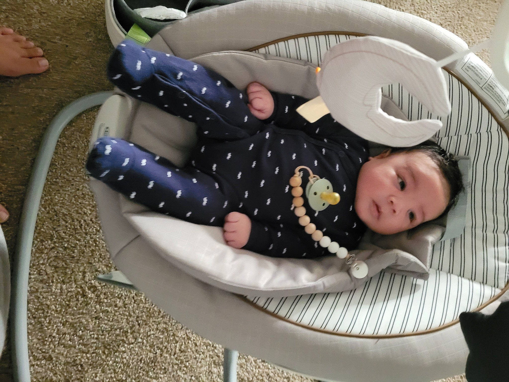 Miguel is registered to the contest to win money with this photo: baby, baby_carriage, baby_products, baby_safety, baby_toddler_clothing, baby_toys, child, comfort, cradle, infant_bed, lap, linens, pattern, person, personal_protective_equipment, sitting, smile, toddler