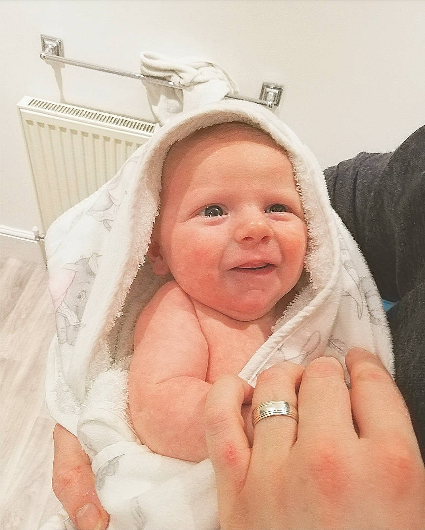 Noah is registered to the contest to win money with this photo: baby, birth, cheek, child, ear, eye, face, facial_expression, fashion_accessory, finger, hair_accessory, hand, happy, head, nose, person, product, skin, smile, toddler