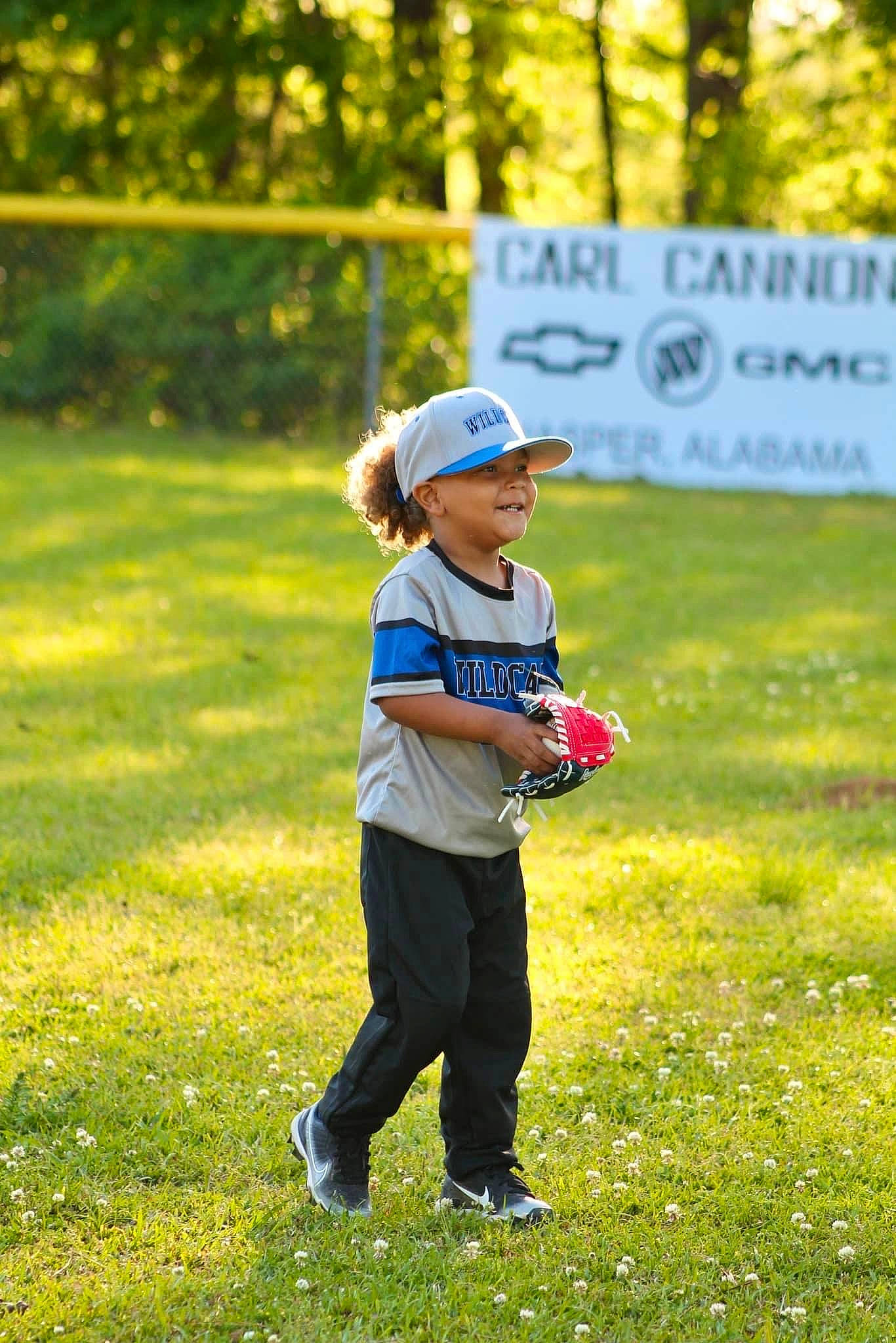 Brentlee is registered to the contest to win money with this photo: baseball_cap, cap, child, clothing, competition_event, fun, grass, grassland, happy, hat, headwear, joy, landscape, lawn, leisure, meadow, people_in_nature, person, plant, recreation