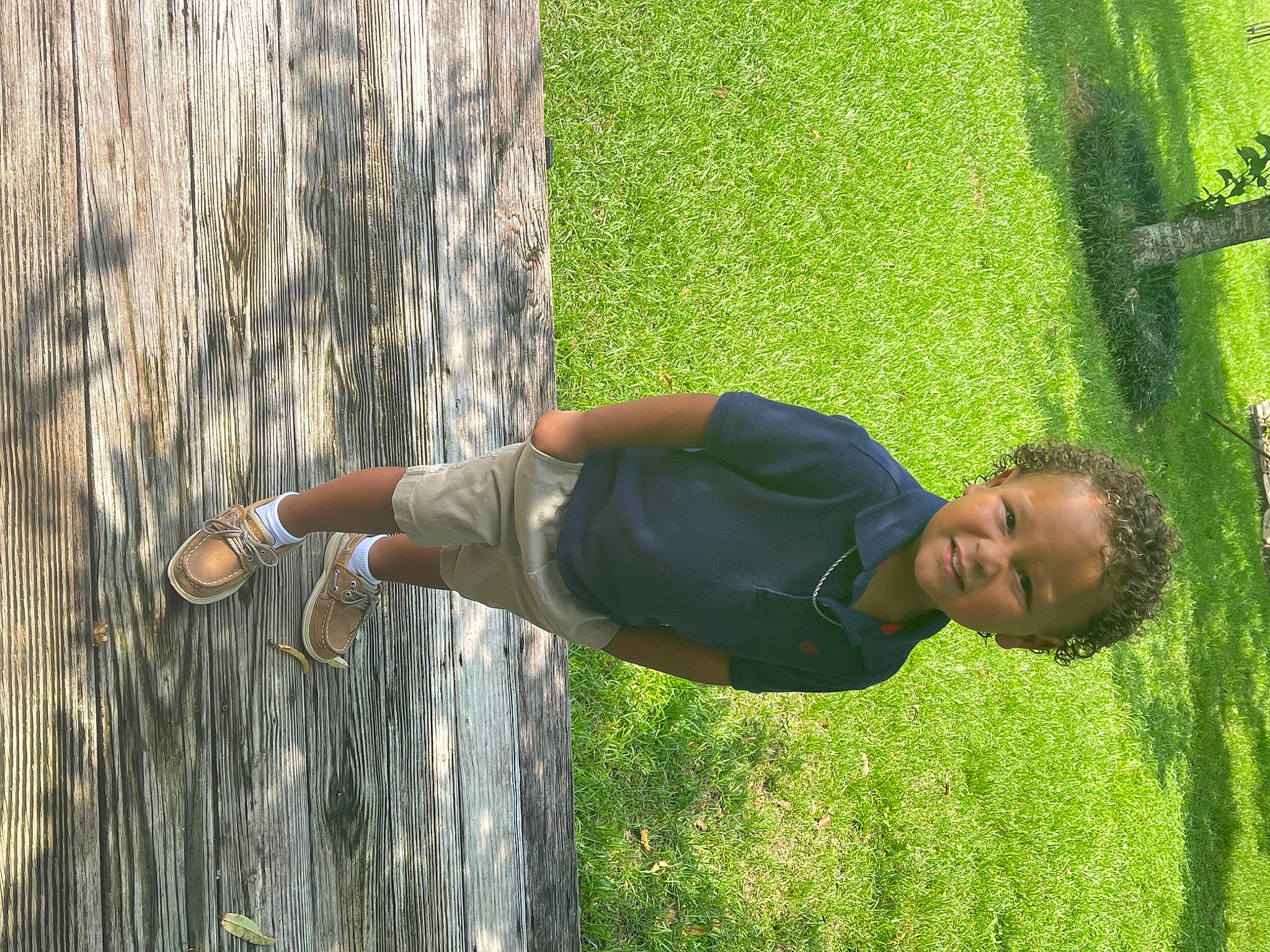 Brentlee is registered to the contest to win money with this photo: child, elbow, fun, grass, grassland, happy, human_body, human_leg, knee, leisure, people_in_nature, person, plant, recreation, shrub, thigh, toddler, tree, trunk, wood