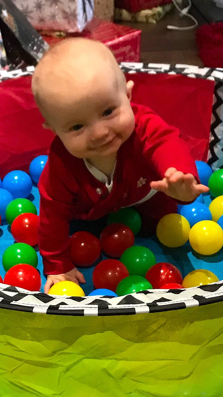Kayden is registered to the contest to win money with this photo: baby_playing_with_toys, baby_toys, ball, ball_pit, child, fun, headwear, joy, leisure, person, play, toddler, toy
