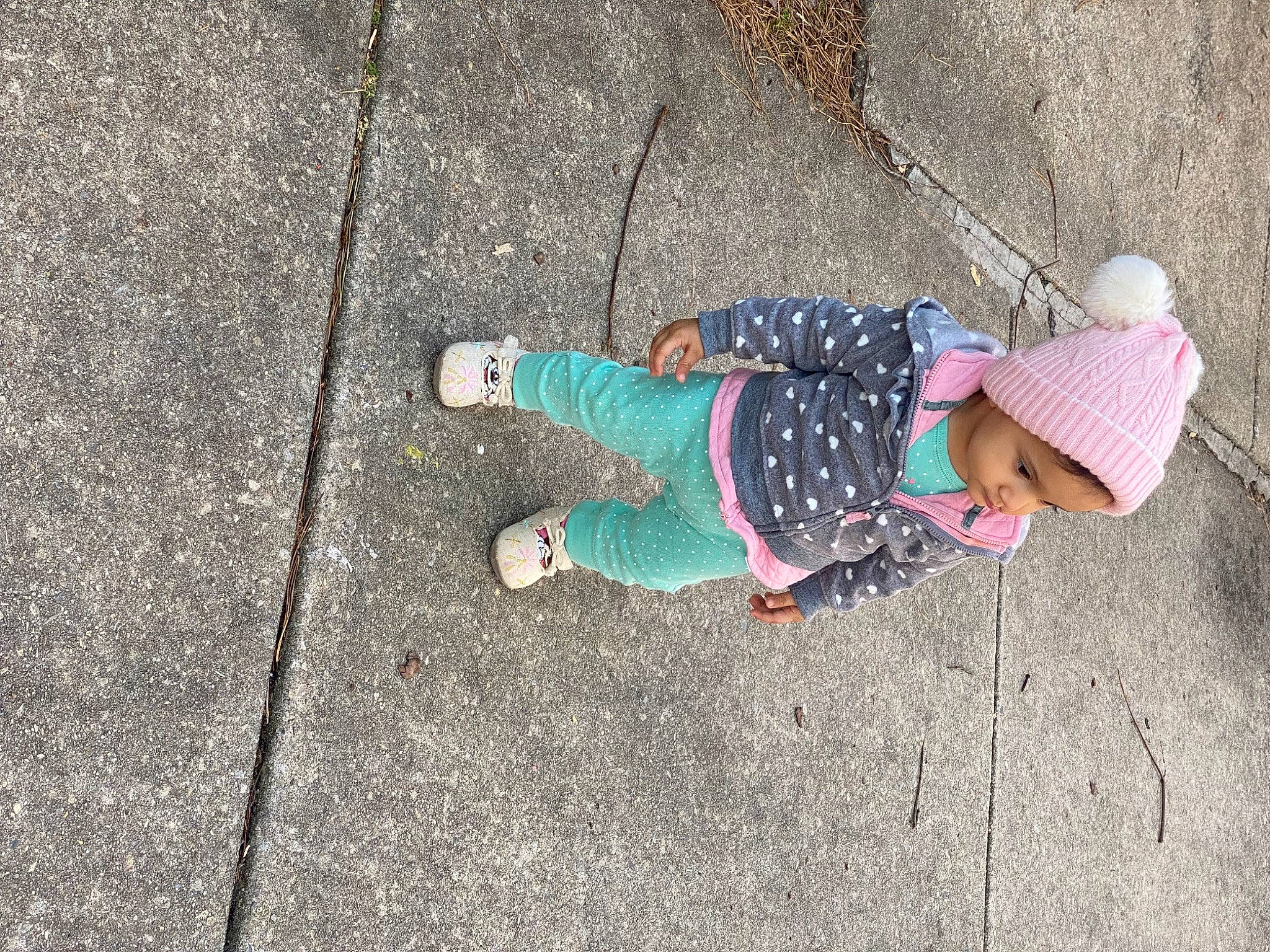 Iris joined the competition — help win amazing prizes! asphalt, baby, child, city, concrete, fun, grass, headwear, human_leg, leg, leisure, pattern, person, recreation, road_surface, shadow, sidewalk, sitting, sneakers, soil