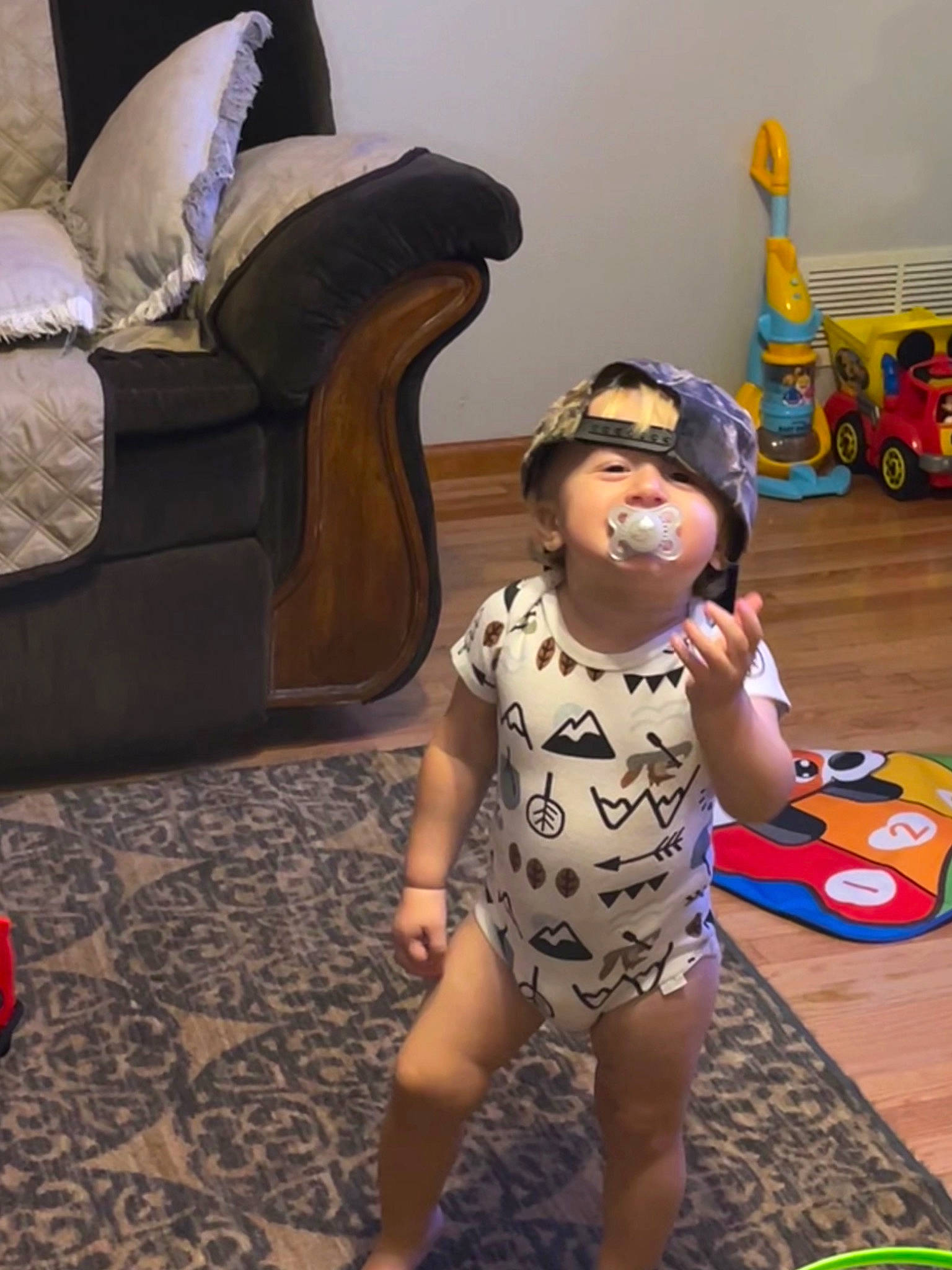 Christian is registered to the contest to win money with this photo: barefoot, child, comfort, floor, flooring, foot, fun, hardwood, human_leg, person, personal_protective_equipment, room, shoe, sitting, sneakers, thigh, tire, toddler, vacation, wheel