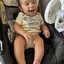 Erick joined the competition — help win amazing prizes! baby, smiling, mickey_mouse, onesie, car_seat, fan, infant, happy, child, cute, indoors, seat, clothing, skin, person, foot, hand, head, comfort, expression
