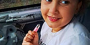 Amaryllis joined the competition — help win amazing prizes! candid, car_interior, casual, child, daylight, fence, girl, happy, holding_object, jewelry, outdoor, pink, portrait, seat, short_hair, smile, trees, white_tshirt, window, young