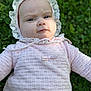 Millie is registered to the contest to win money with this photo: baby, bonnet, cap, clothing, coat, dress, face, grass, hat, head, hood, jacket, knitwear, longsleeve, person, photography, plant, portrait, sleeve, sweater